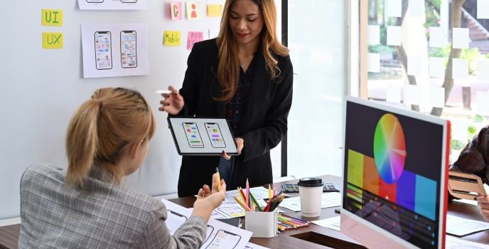 Business-growth-consulting-services-app-design-development-consulting Two women providing app design and development consulting as a business growth consulting service