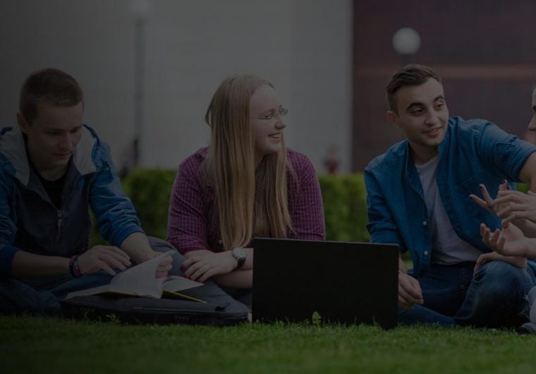 AUBG-background A background image for AUBG of three students sitting on the grass with laptops