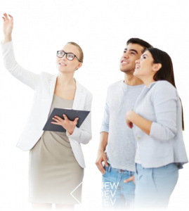 NewDevRev-hero A real estate worker motions off camera to a couple for NewDevRev's lifestyle image