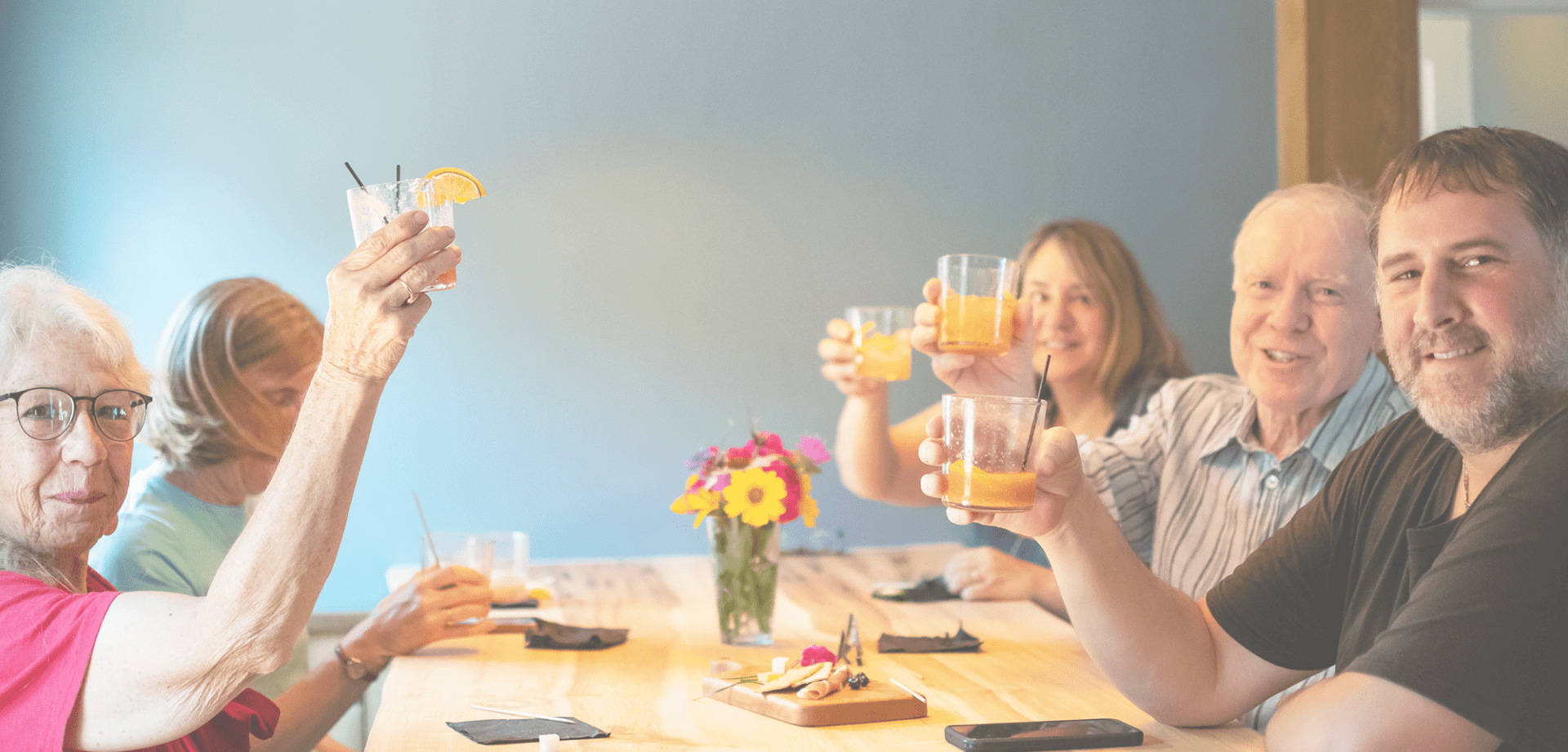 headwaters-hero A family raise their glasses at Headwaters Restaurant & Pub