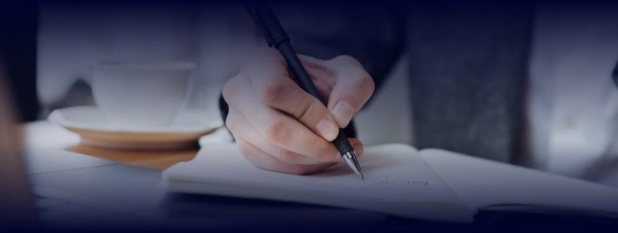devensoft_background_2 A person writing on a paper