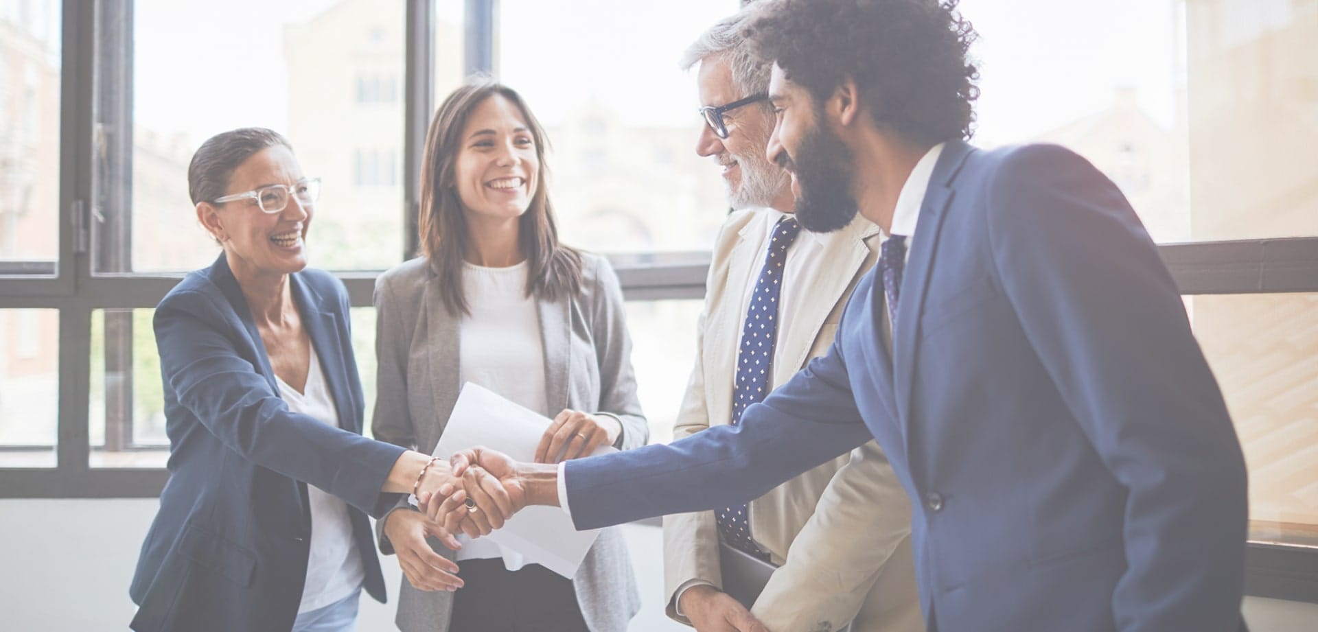 Background image for H2 Compiance's case study showing people in business suits shaking hands