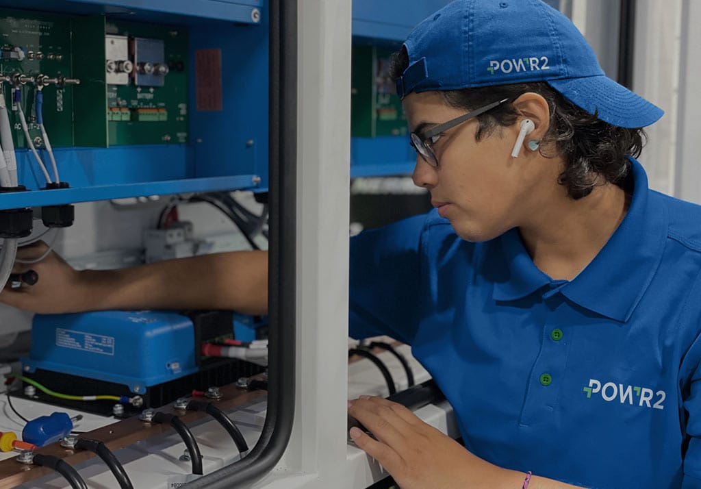digital-marketing-agency-manufacturing Manufacturing technician inspecting electrical equipment inside an industrial control cabinet.