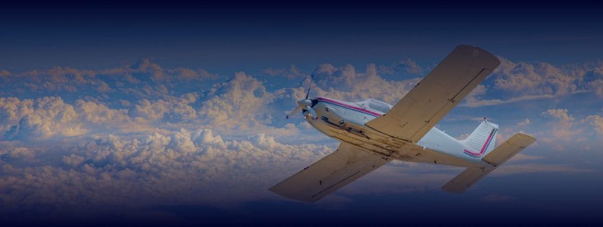national-aviation-background_2 Small propeller aircraft banking in flight above a dramatic cloudscape at golden hour with a deep blue gradient overlay